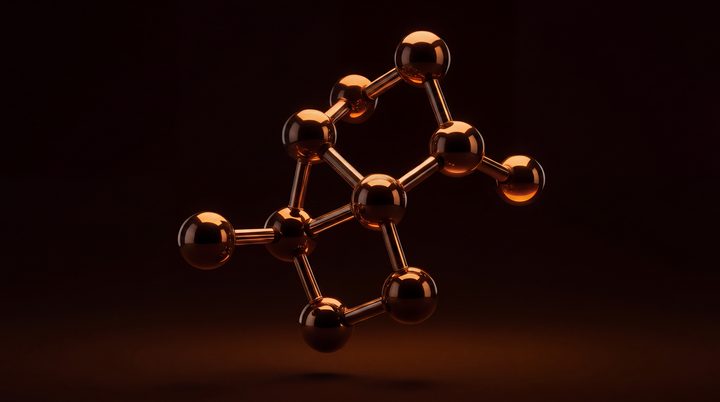 A ball-and-stick molecular model in glossy amber on black.