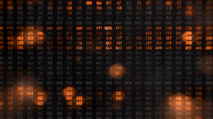 A dense grid of glowing amber and grey numbers, a tabular dataset.