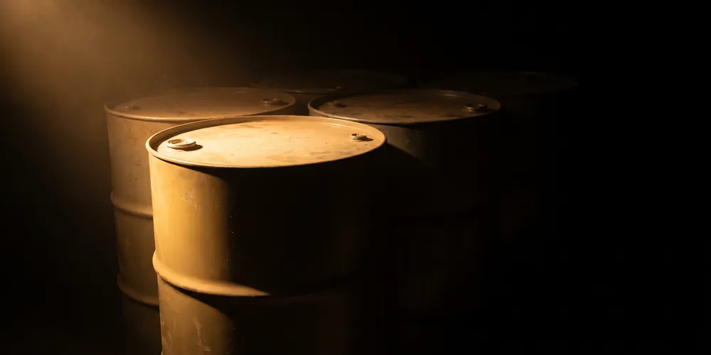 Steel drums in a store, the nearest one lit and the rest falling into shadow