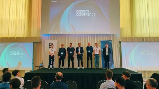 Seven speakers lined up on stage under the CADFEM Conference Lyon screen