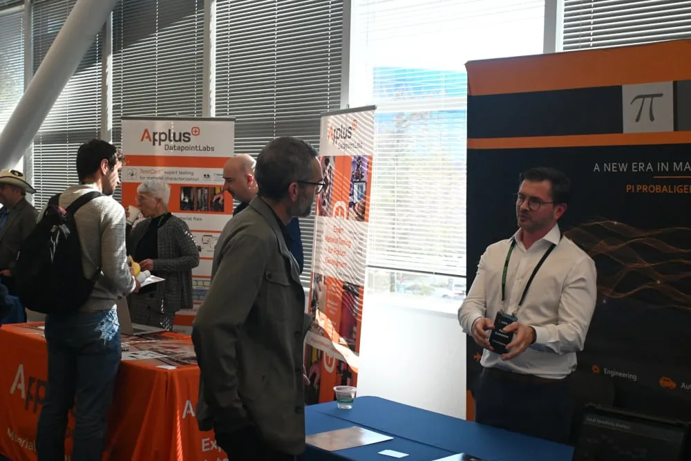 PI Probaligence exhibition banner at OzenCon 2025 with Dr. Cremanns talking to booth visitors
